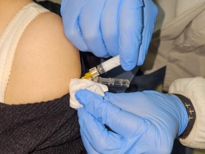 Vaccine being injected into a woman's arm