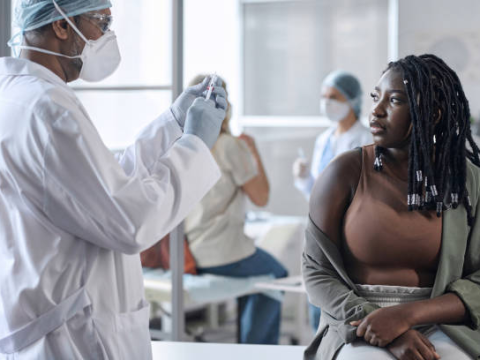 Doctor about to vaccinate woman