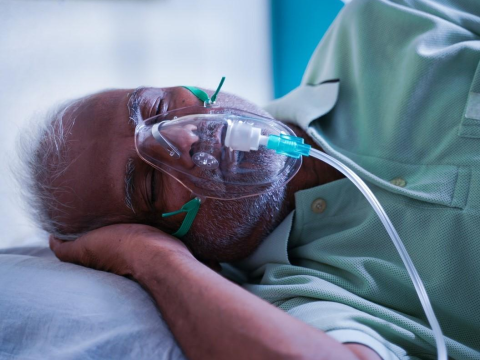 Man with oxygen mask at home