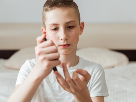 Boy checking his glucose levels