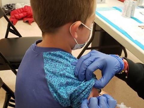 Boy receiving COVID vaccination