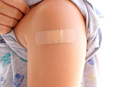 Vaccinated child with bandage on arm