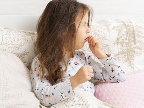 Coughing girl in bed