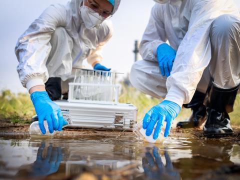 Workers taking water samples