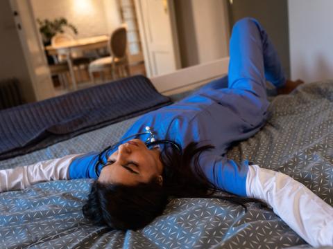 Exhausted nurse on bed