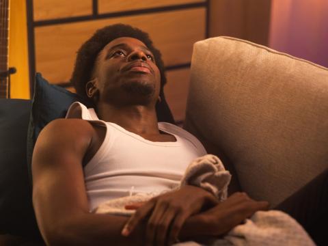 Exhausted young man on couch