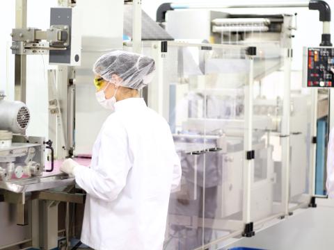 Female worker at pharmaceutical factory