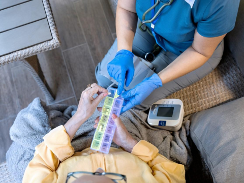 Nurse giving resident pills