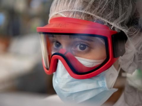 Healthcare worker wearing a medical mask on top of a respirator