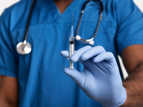 Healthcare worker with vaccine dose