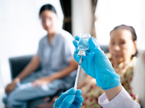 Nurse pulling up flu vaccine in syringe