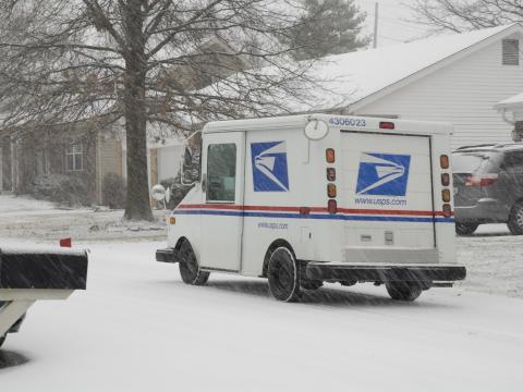 mail truck in snowstorm