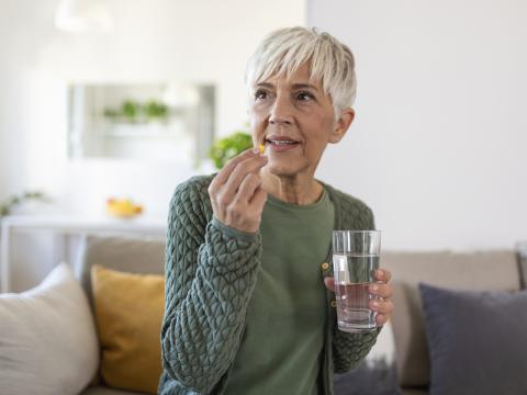 Older woman taking pill