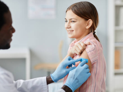 Teen girl being vaccinated