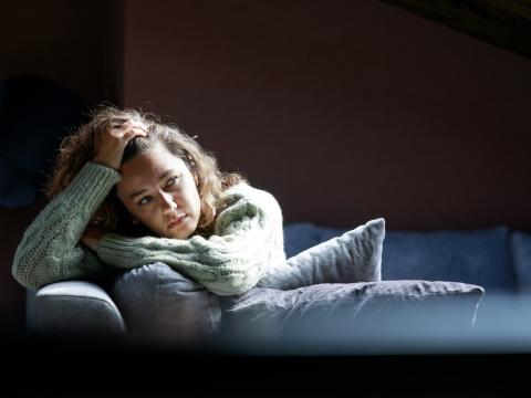 Tired young woman on sofa