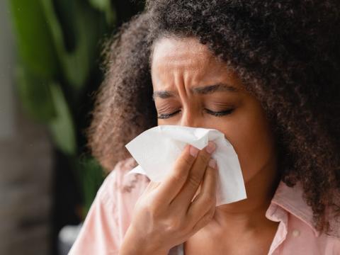 Woman blowing nose