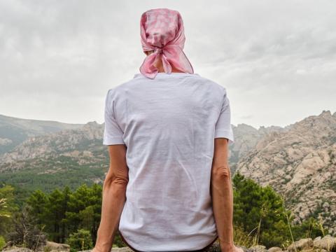 Woman with cancer on rock