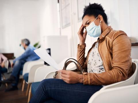 Woman wearing mask in waiting room