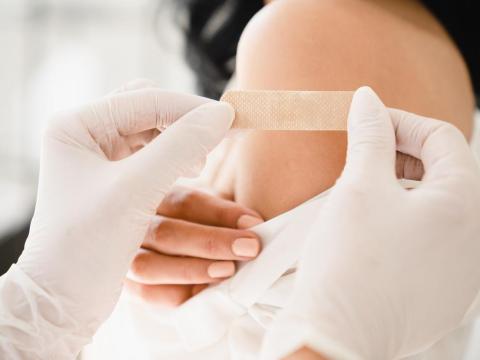 Young woman with bandaid on arm