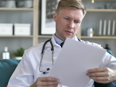 Doctor reading a medical chart