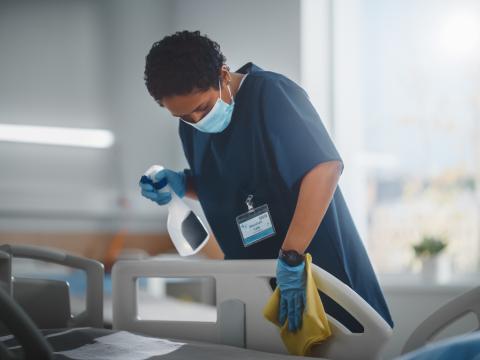 Nurse cleaning hospital bed
