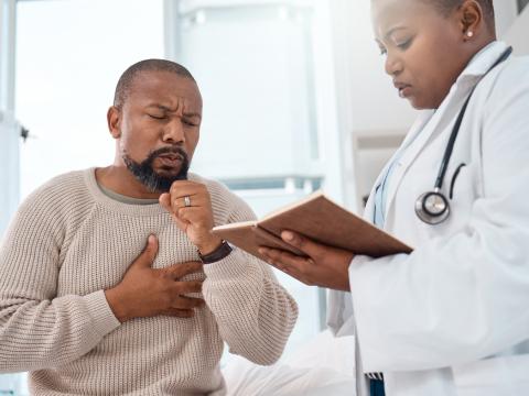 Man coughing at doctor's office