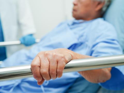 Hospital patient holding bed rail