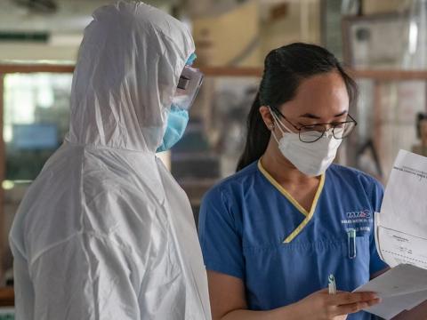 Two healthcare workers wearing personal protective equipment