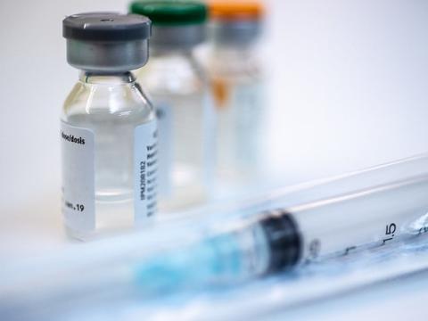 Three vaccine vials and syringe