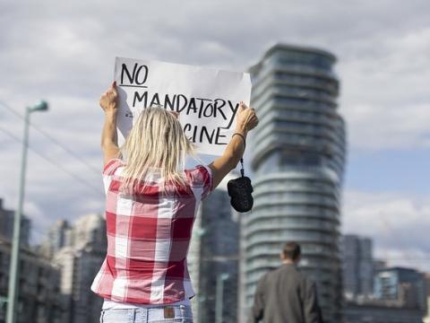 Anti-vaccine protester with sign