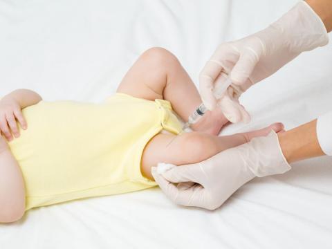 Baby receiving vaccine in thigh