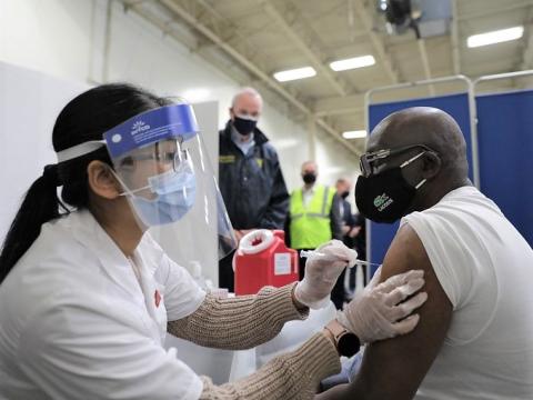 Bald man getting COVID vaccine