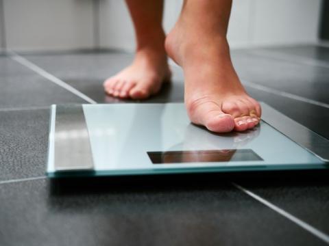 Bare feet stepping onto scale