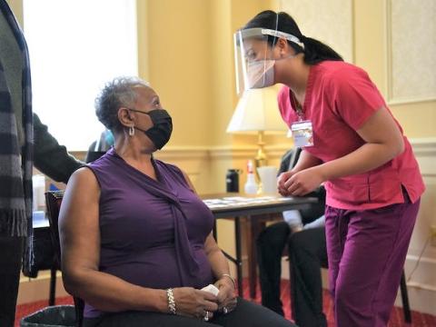 Woman getting prepped for COVID vaccine