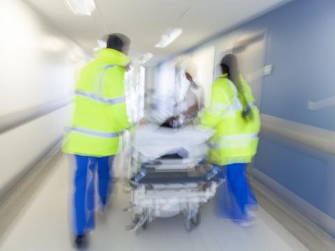 Blurred gurney in hospital corridor