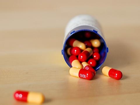 Capsules spilling from bottle onto table