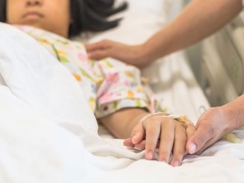 Caring for girl in hospital bed
