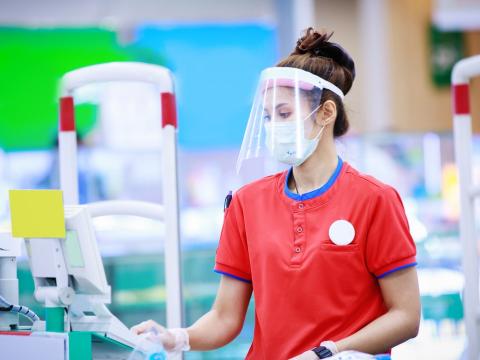 Cashier with mask and face shield