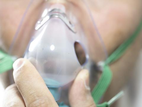 Close-up of large man with oxygen mask