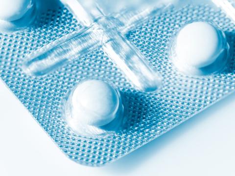 Closeup of white pills in bubble packet