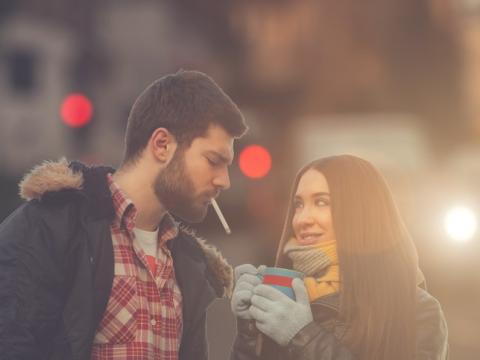 Couple outdoors man smoking