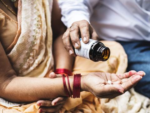 Couple in India with bottle of pills