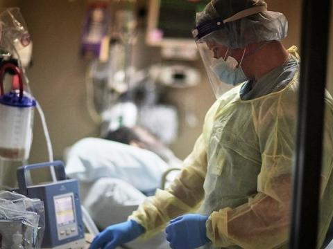 Doctor at bedside of COVID-19 patient