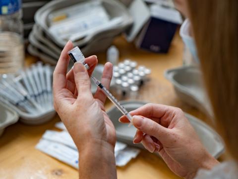 COVID vaccinator with syringes