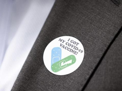 COVID vaccine sticker on lapel