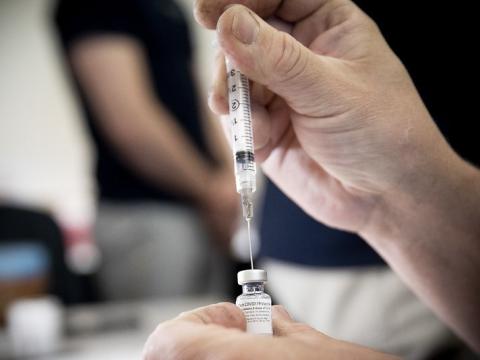 COVID-19 vaccine being drawn into a syringe