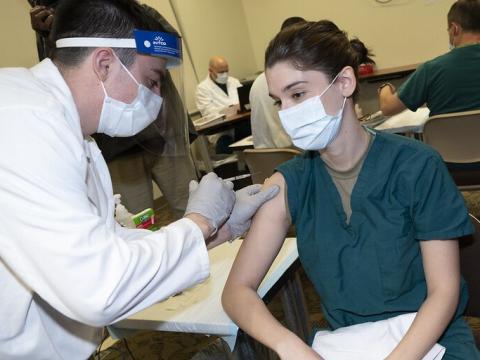Doctor getting the COVID vaccine