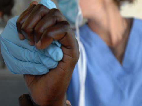Doctor holding patient's hand