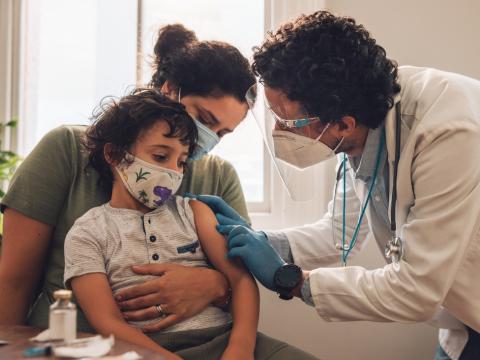 Doc prepping young boy for COVID vaccine