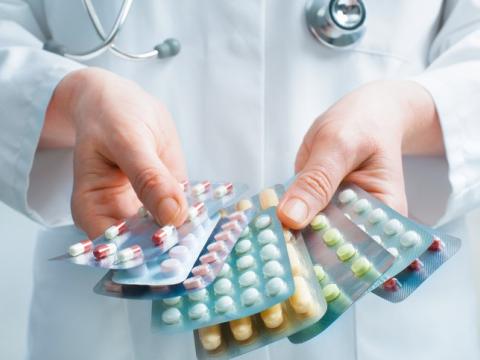 Doctor with packs of pills